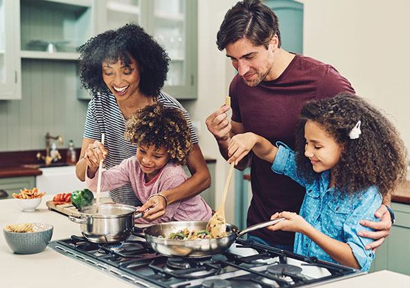 Family cooking a home cooked healthy meal. 