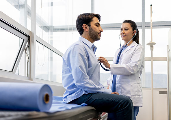 A patient gets his heart checked by a cardiologist.