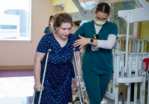 Havely walking with crutches after undergoing hip surgery