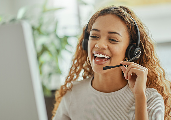 An agent is talking on a headset with a customer to help choose a health plan
